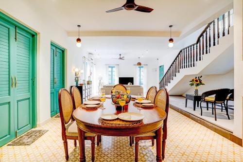 a dining room with a table and chairs at Valencia By DanCenter - 3 Bhk Villa in Siolim in Siolim