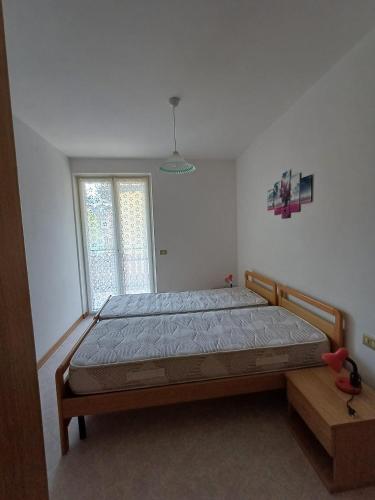 a bedroom with a bed and a window at Fiore in Pieve Di Ledro