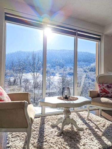a living room with a large window with a view at Rest House in Olovo