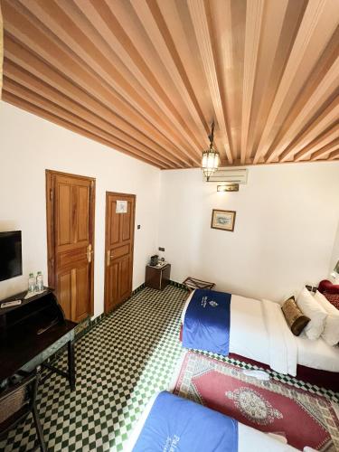 a bedroom with a bed and a television in a room at Le Riad Palais d'hotes Suites & Spa Fes in Fès