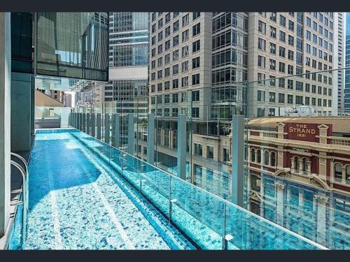 a view of a swimming pool on top of a building at Luxurious &cozy apartment with pool and gym in Sydney CBD in Sydney