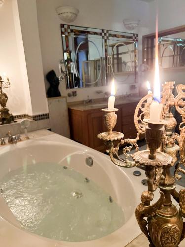 a bathroom with a bath tub with two candles at Le Riad Palais d'hotes Suites & Spa Fes in Fès