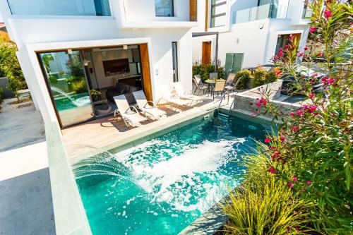 a swimming pool in the middle of a house at Villa Laurus 2 by Ezoria Villas in Paphos