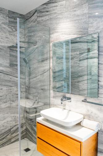 a bathroom with a sink and a shower at Villa Laurus 2 by Ezoria Villas in Paphos