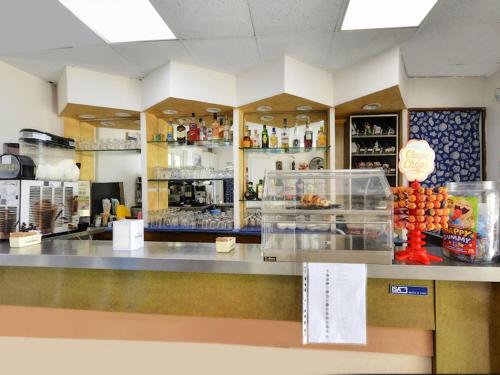 a counter in a restaurant with a counter top with food at Villaggio La Bussola in Paola