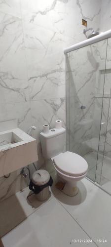 ein Badezimmer mit Toilette, Waschbecken und Dusche in der Unterkunft Mansão Ponta da Asa in Coruripe