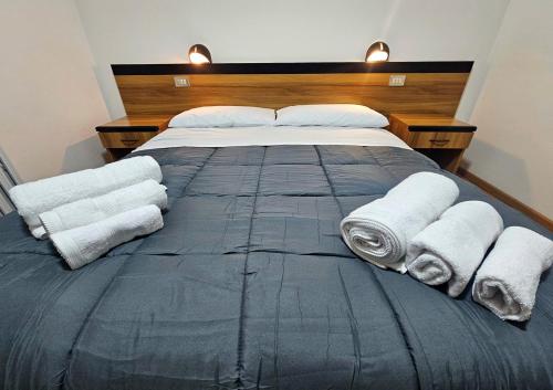 a bedroom with a bed with towels on it at TEA San Pellegrino - DOLOMITI in Falcade