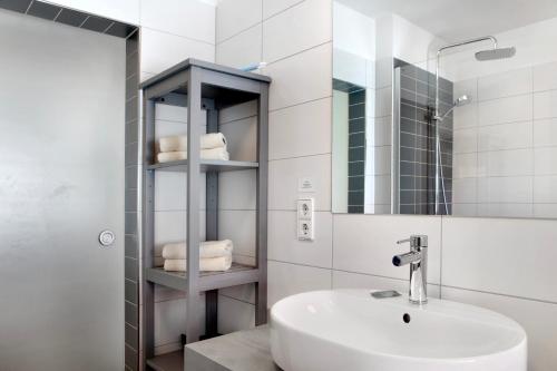 a white bathroom with a sink and a mirror at Ferienwohnung Tannenblick 6-2 in Oberhof