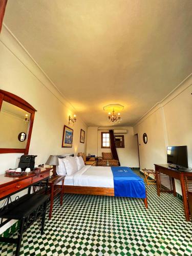 a hotel room with a bed and a desk at Le Riad Palais d'hotes Suites & Spa Fes in Fès
