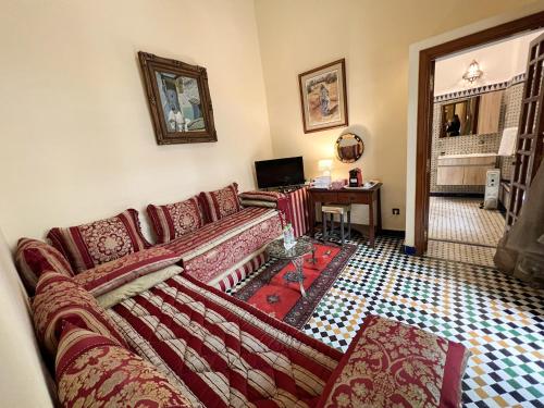 a living room with a couch and a table at Le Riad Palais d'hotes Suites & Spa Fes in Fès