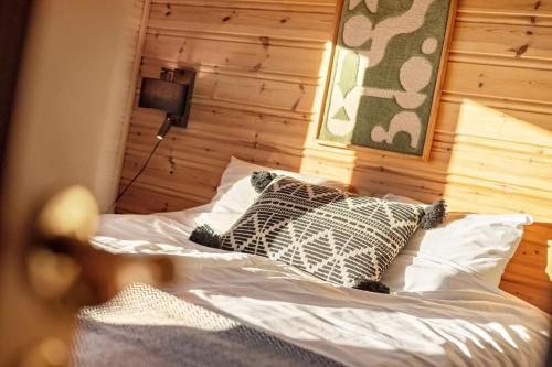 a bed with two pillows on it in a room at Verhøf Hytte - 9p - With Sauna & Hot Tub in Vradal