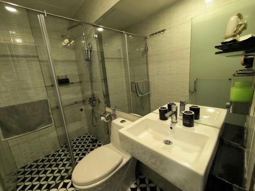 a bathroom with a toilet and a sink and a shower at Eclipse Legend Hotel in Hanoi