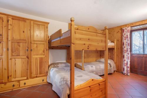 two bunk beds in a room with wooden cabinets at Casa Chamonin Pila in Gressan