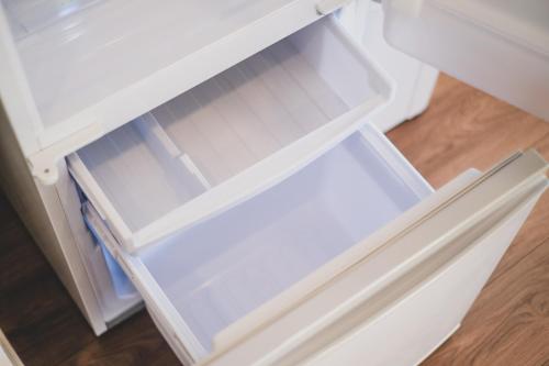 an open drawer of a white refrigerator at Odysis Onna Resort Hotel in Onna