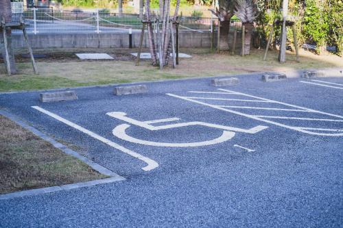 a parking lot with a bus sign on the ground at Odysis Onna Resort Hotel in Onna