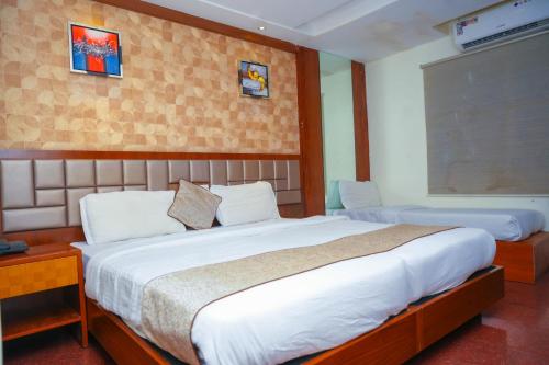a bedroom with a large bed in a room at Octave Hotel AM Garden in Bangalore