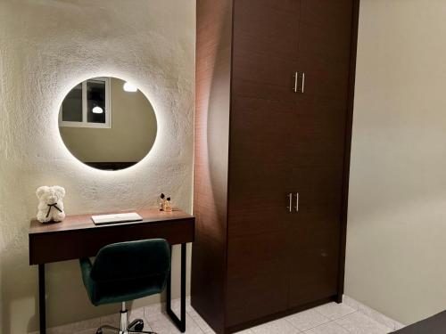 a dressing room with a desk and a mirror at Hillview Apartments Chalkis in Kánithos