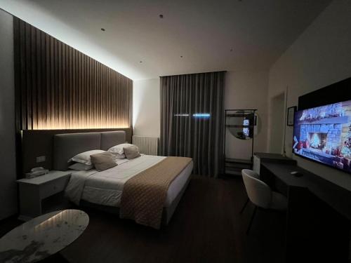 a hotel room with a bed and a flat screen tv at Brianza Home in Giussano