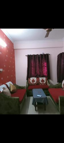 a living room with two couches and a table at Jamuna homestays in Secunderabad