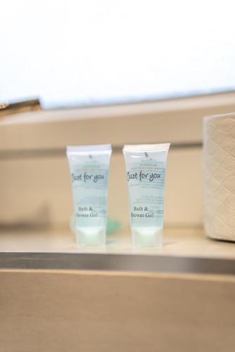 two bottles of just for you cream on a shelf at Skye House in Grangemouth