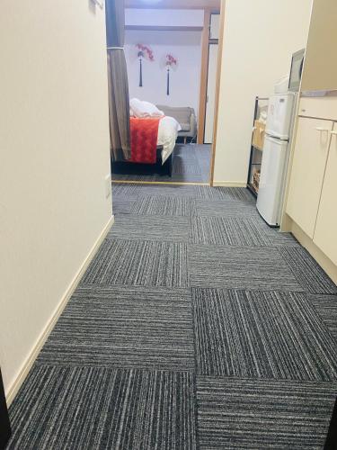Cama o camas de una habitación en 大阪梅田淀川花民宿家庭房b套