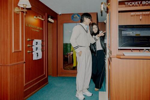 a man and a woman standing in a room at Stay Passport Express Spa Dangsan in Seoul