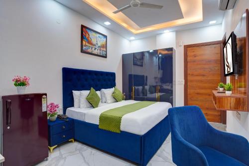 a bedroom with a blue bed and a blue chair at Limewood Stay - Sector 29 Gurgaon in Gurgaon