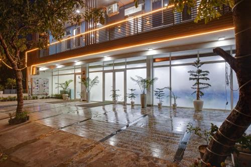 a building with potted plants in front of a building at Limewood Stay - Sector 29 Gurgaon in Gurgaon