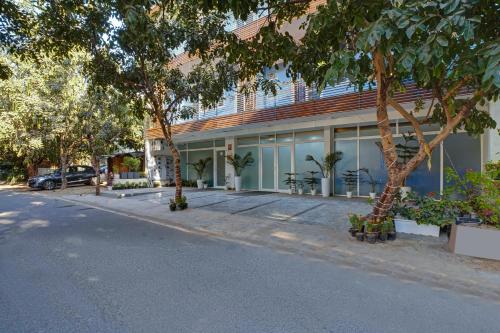 a building with trees on the side of a street at Limewood Stay - Sector 29 Gurgaon in Gurgaon