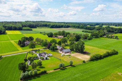 an aerial view of a house in a green field at Erve Lindehof in Lochem