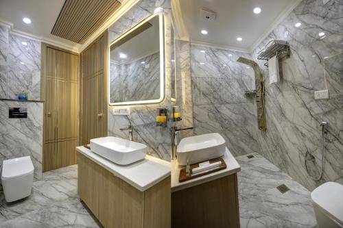 a bathroom with a toilet and a sink and a shower at Miyabi suites in Gurgaon