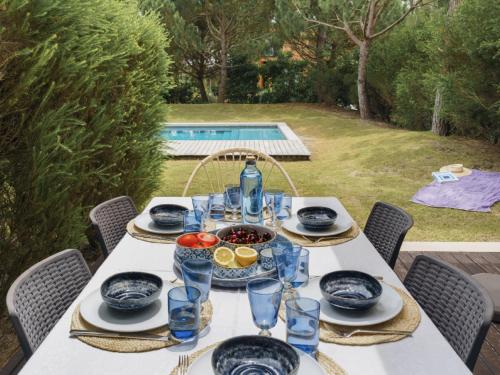 a table with plates and bowls of food on it at Pool Beach & Golf Troia Reserve V3 in Troia