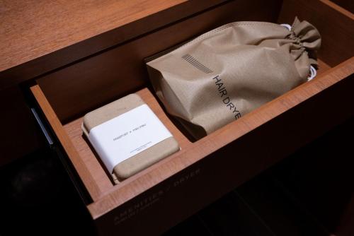 a drawer with a box and a bag in it at Stay Passport Express Spa Dangsan in Seoul