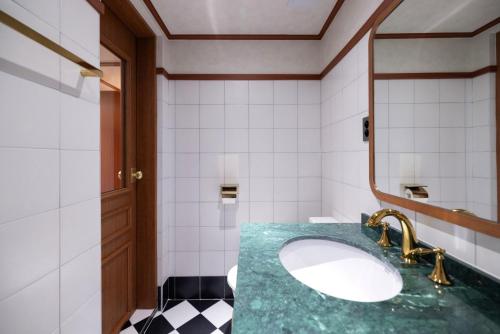 a bathroom with a sink and a mirror at Stay Passport Express Spa Dangsan in Seoul