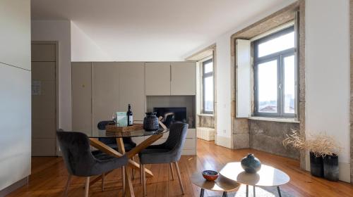 a living room with a table and chairs and a fireplace at Authentic Porto House in Porto