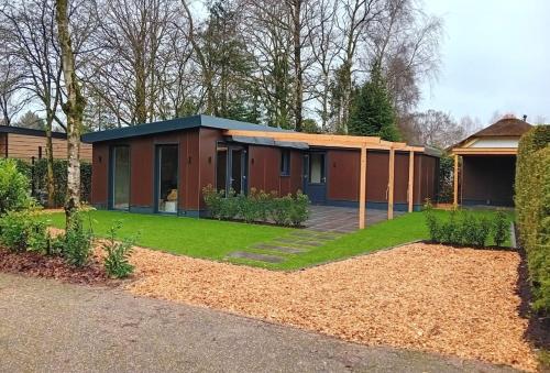a house with a garden in front of it at De Bospaddenstoel 4-19 in Putten