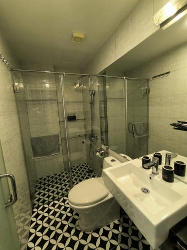 a bathroom with a toilet and a sink and a shower at Eclipse Legend Hotel in Hanoi