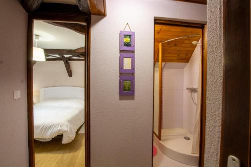 a mirror in a room with a bedroom and a tub at Gite des noisetiers in Lacropte