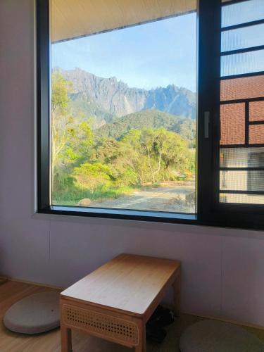 a window with a view of a mountain view at The Pampines Villa, Mount Kinabalu in Ranau