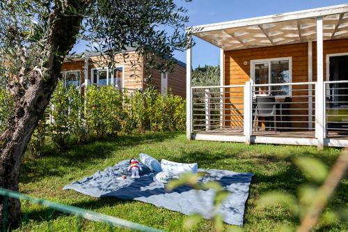 a toy on a blanket in the yard next to a house at Campeggio Europa Silvella in San Felice del Benaco
