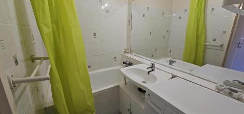 une salle de bain avec un lavabo, une baignoire et un miroir dans l'établissement Studio avec vue magnifique au Corbier pied des pistes, à Villarembert