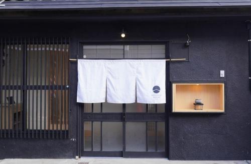 a window with a white towel hanging in front of a building at Kintsugi House Tajimi in Tajimi