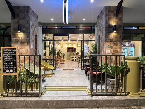 a restaurant with tables and chairs in a building at Khlong bang phra boutique hotel in Trat