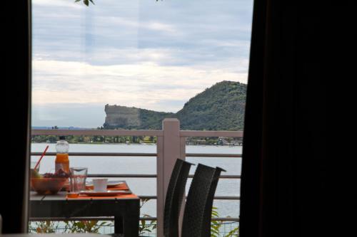 a table with a view of the water from a balcony at Campeggio Europa Silvella in San Felice del Benaco
