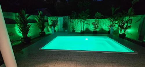 a swimming pool at night with green lights at Prestige Pool Villa by Karon Homes in Karon Beach