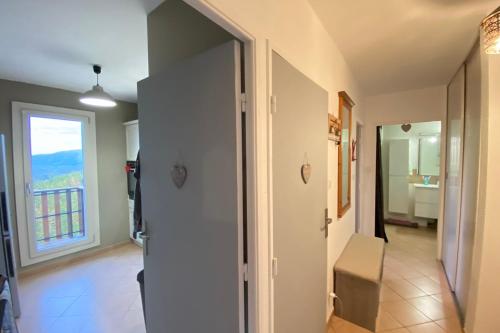 a hallway with a door leading to a bathroom at 06CM - Very nice T2 on the heights of Valberg in Péone