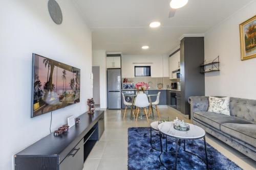 a living room with a couch and a table at Ballito Village Luxury Apartments in Ballito