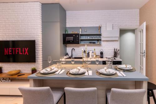 a kitchen and dining room with a table and chairs at AIASTAY Bucharest River Apartments in Bucharest