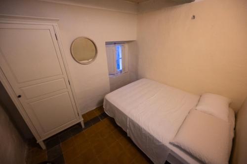 a small bedroom with a white bed and a mirror at Grand Arcanum Apartment 2 - Comfortable and Elegant in Senglea
