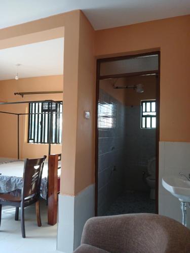a room with a glass door leading to a bathroom at Bedsitter To let in Kisumu